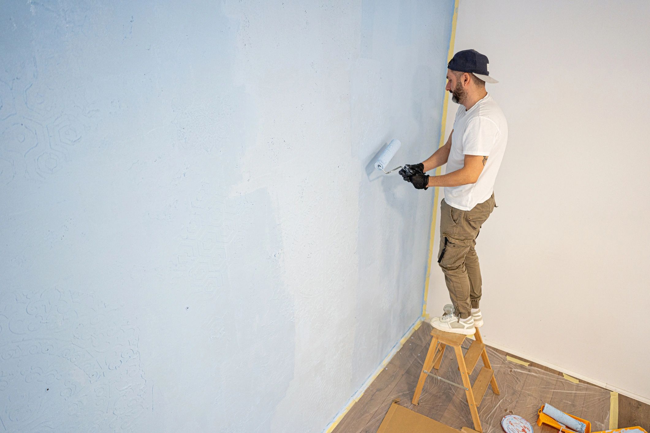 Painter applying fresh paint to an interior wall